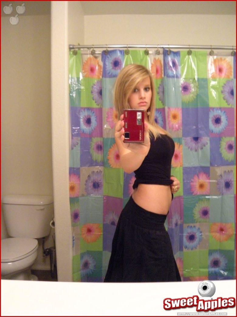 Alisa poses before a mirror