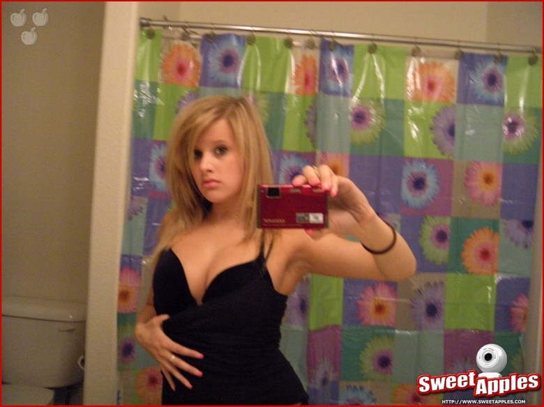 Alisa poses before a mirror