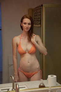 Redhead Dee Dee Lynn in orange bikini