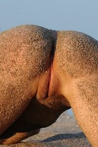 Naked babe posing at the beach